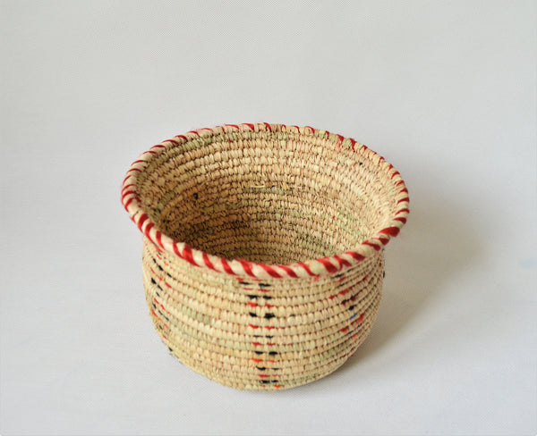 Wide woven bowl decorated with red and black fabric