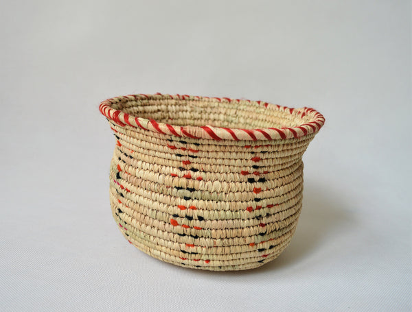 Wide woven bowl decorated with red and black fabric