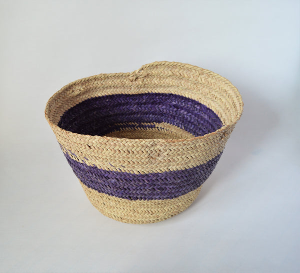 Round straw basket from natural palm leaves with a wide Purple stripe