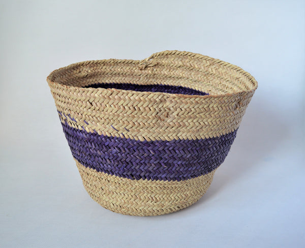 Round straw basket from natural palm leaves with a wide Purple stripe