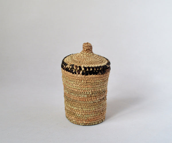 Long woven container lidded with true leather decoration