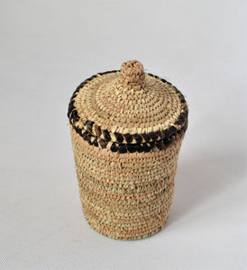 Long woven container lidded with true leather decoration