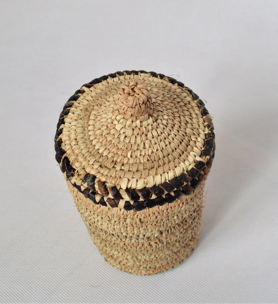 Long woven container lidded with true leather decoration