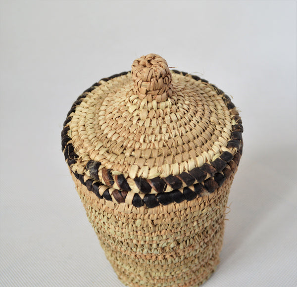 Long woven container lidded with true leather decoration