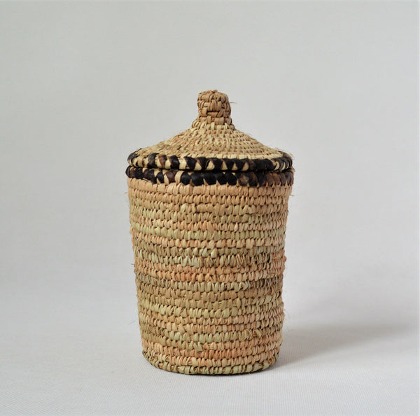 Long woven container lidded with true leather decoration