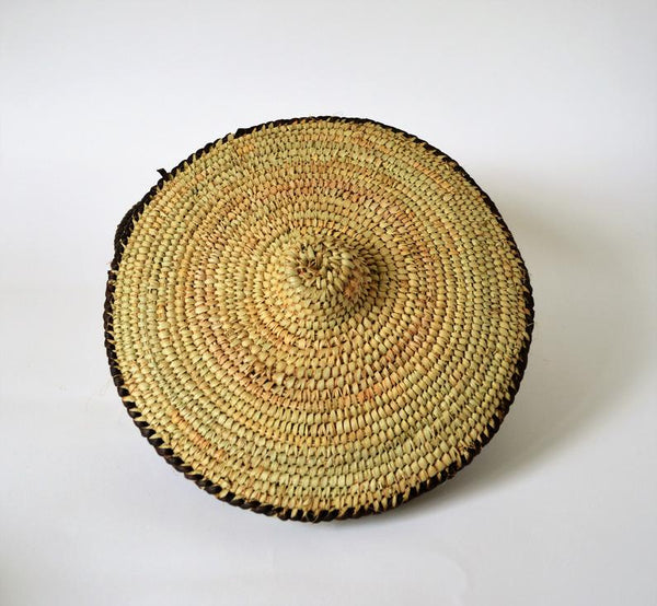 Round woven box decorated with leather