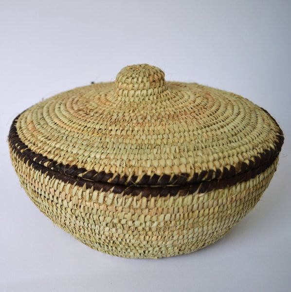 Round woven box decorated with leather