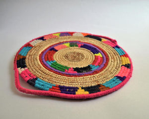 Tribal woven wall basket with wool decoration